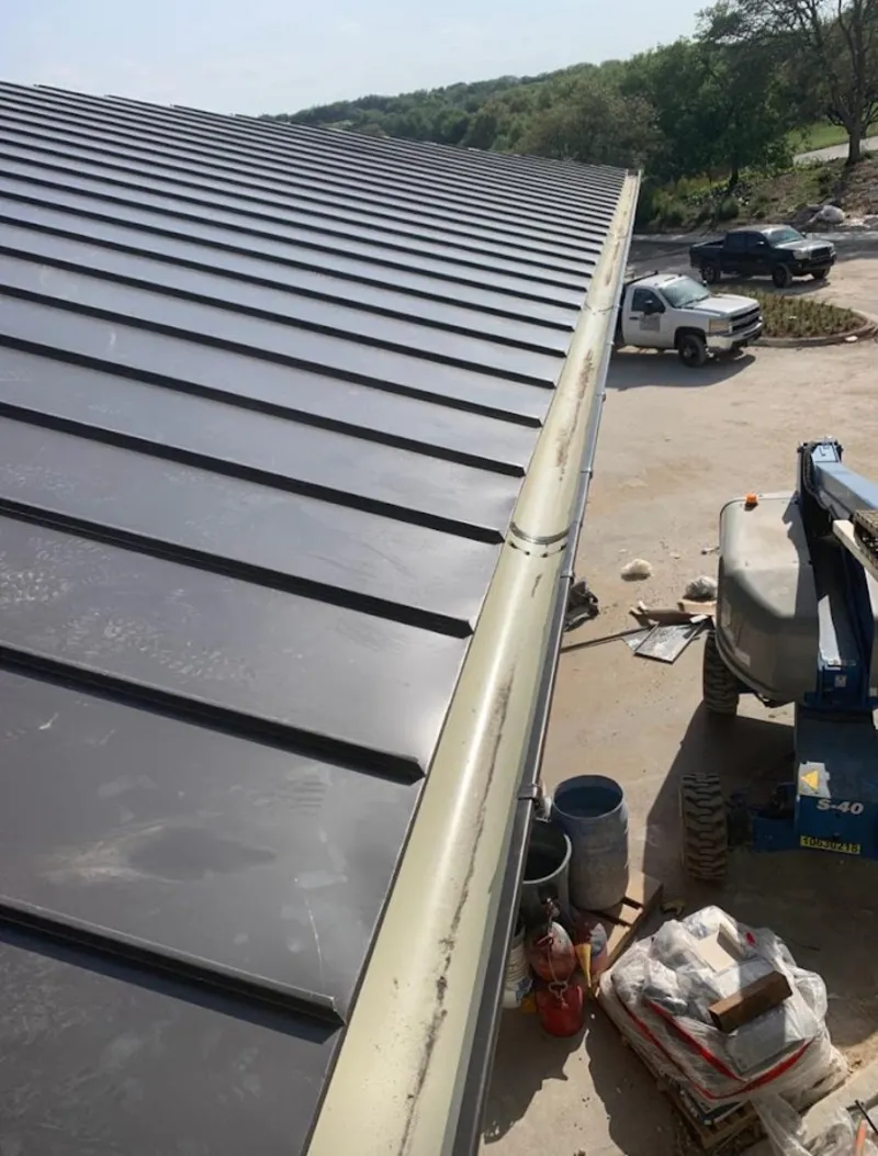 Standing seam panel and gutter detail on a metal roofing jobsite in Amsterdam